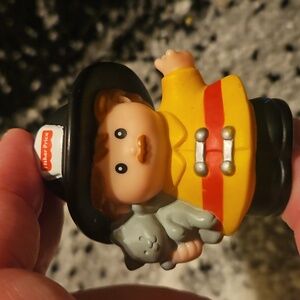 Fisher-Price Little People firefighter figure holding a kitten